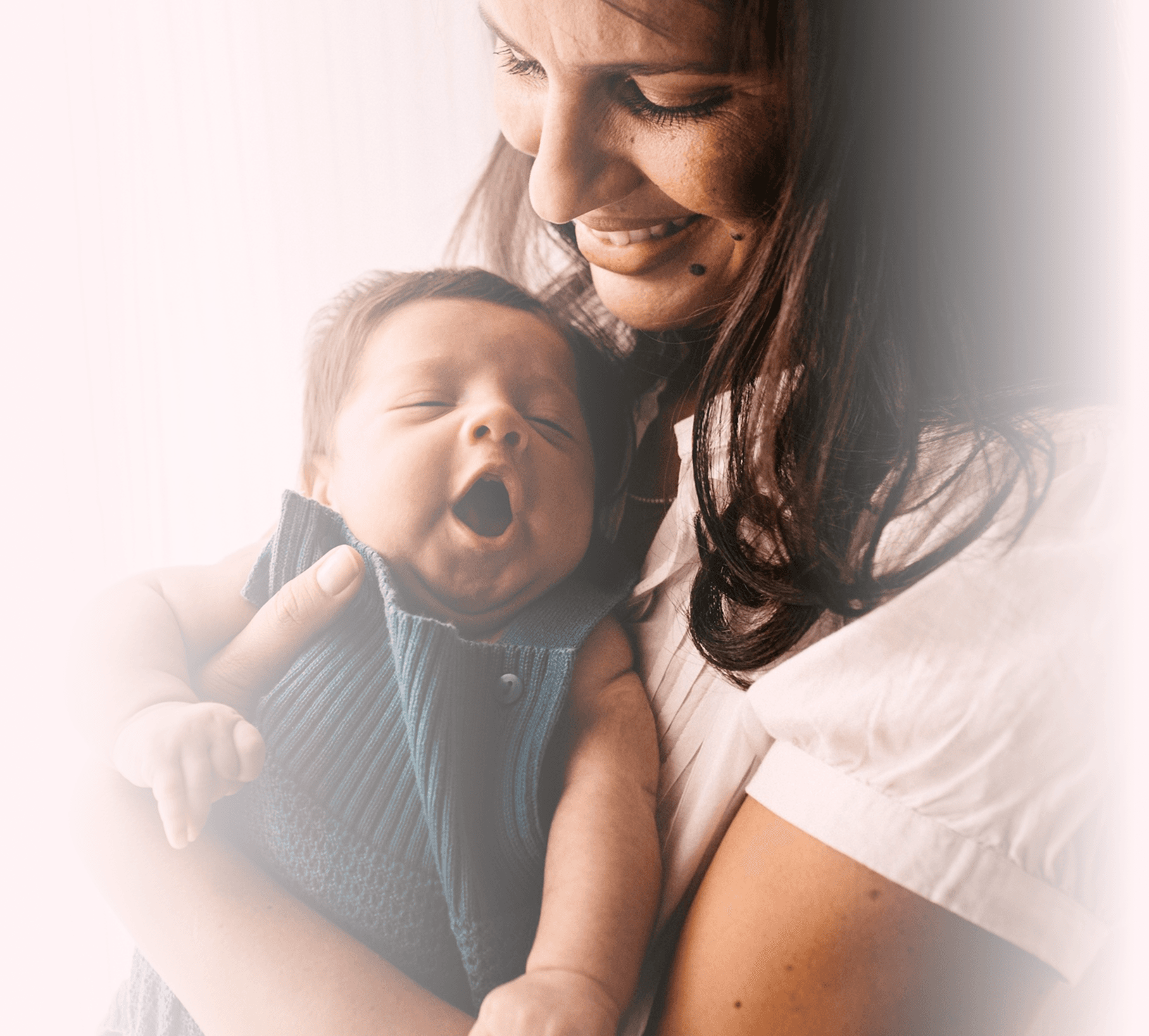 A woman holding a baby serious